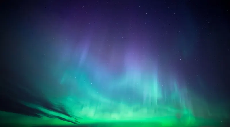 Illustration of the northern lights over an Icelandic landscape